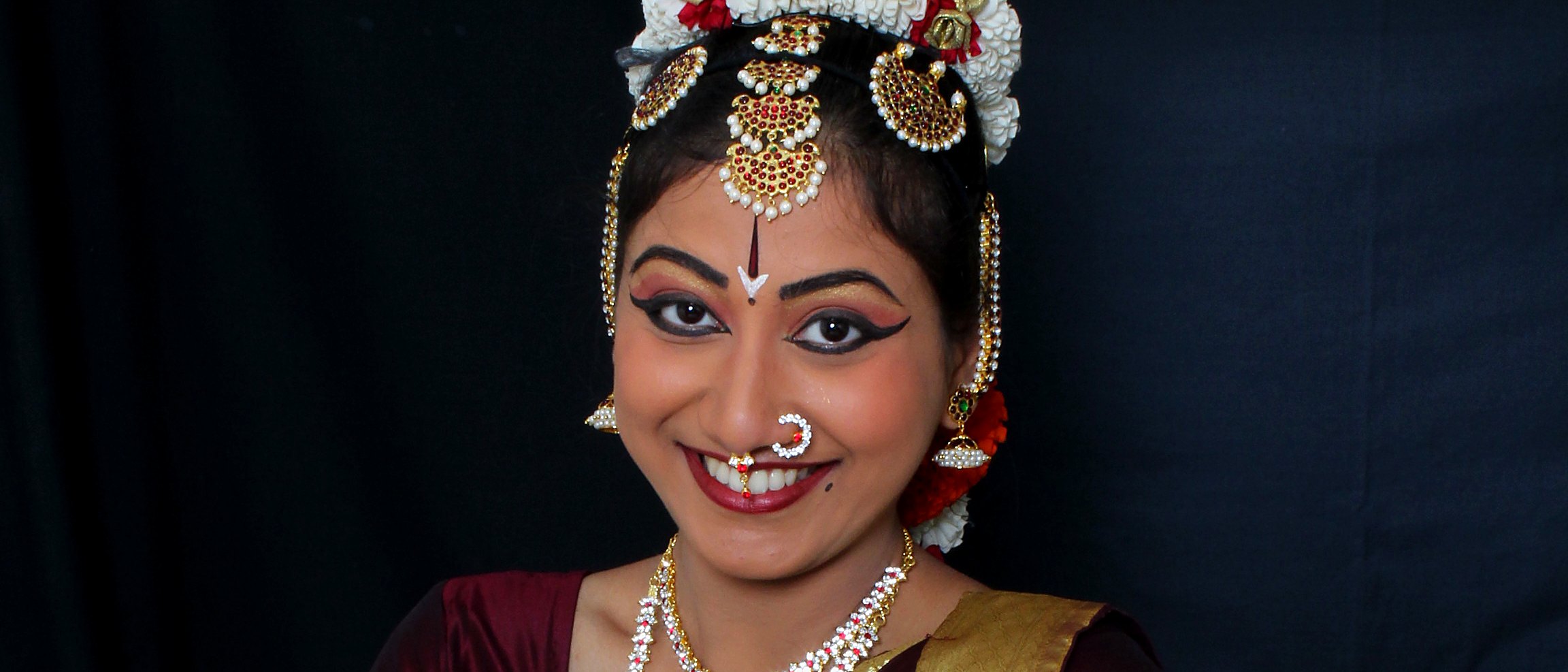 Cinematic crop of a smiling face and hand gesture