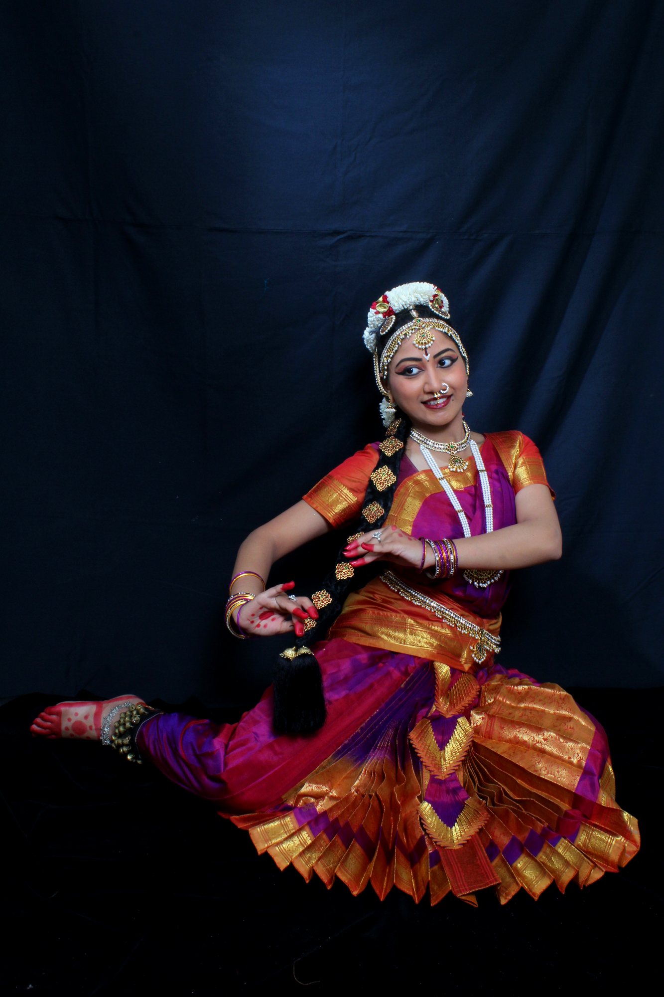 Floor pose in magenta and gold costume