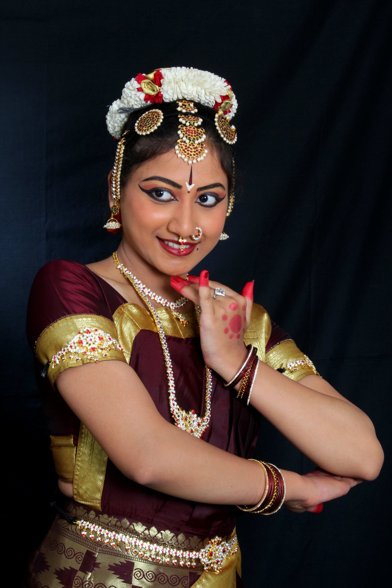 Ambika Ganeshprasad in maroon and gold Bharatanatyam costume
