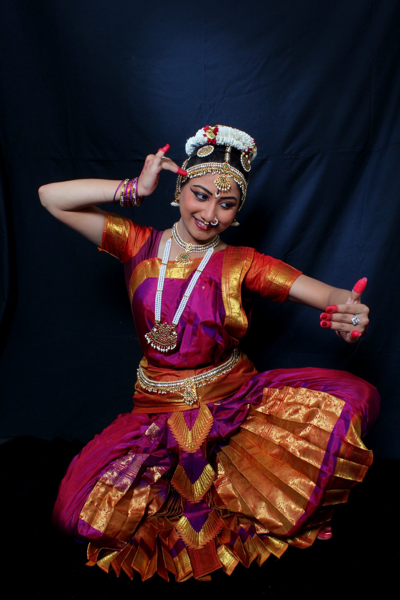 Seated Bharatanatyam pose with an extended arm